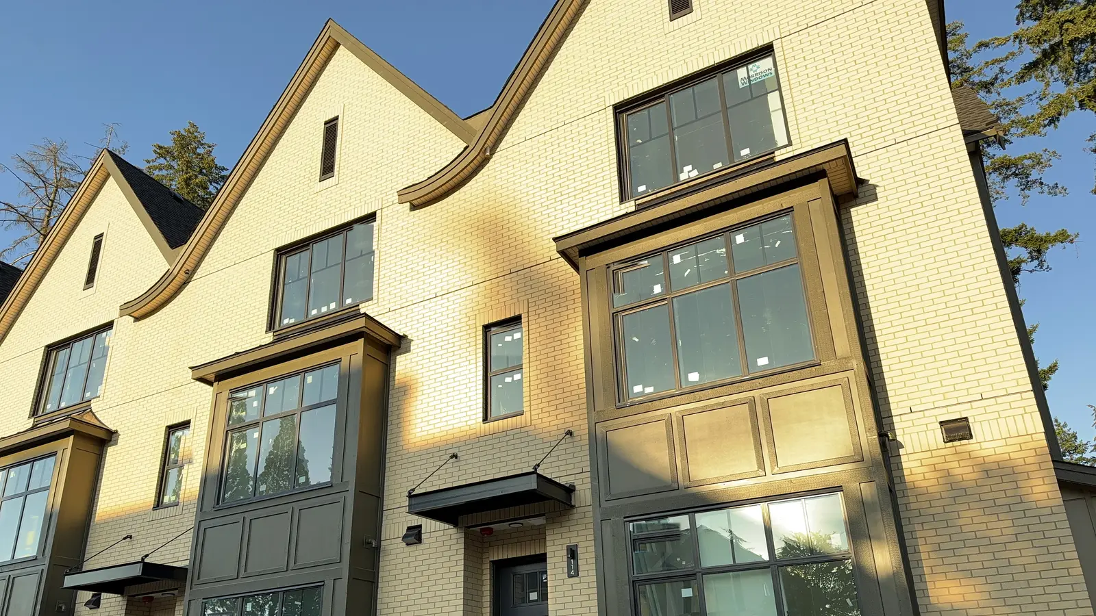 Brick townhouse row finished by Moonrise Construction, golden hour in the Fraser Valley